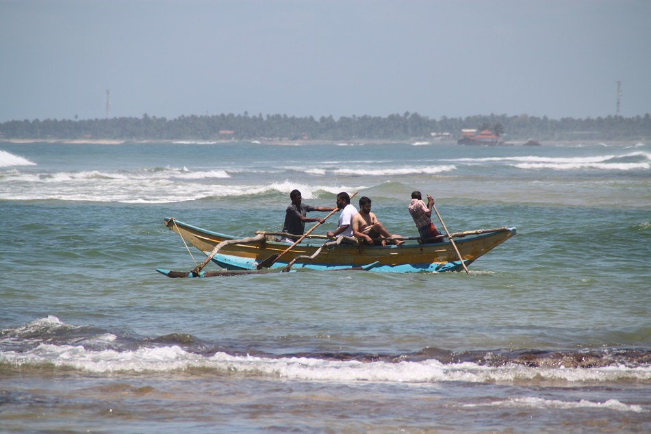 Men on A Traditional Boat Going Against the Big Waves